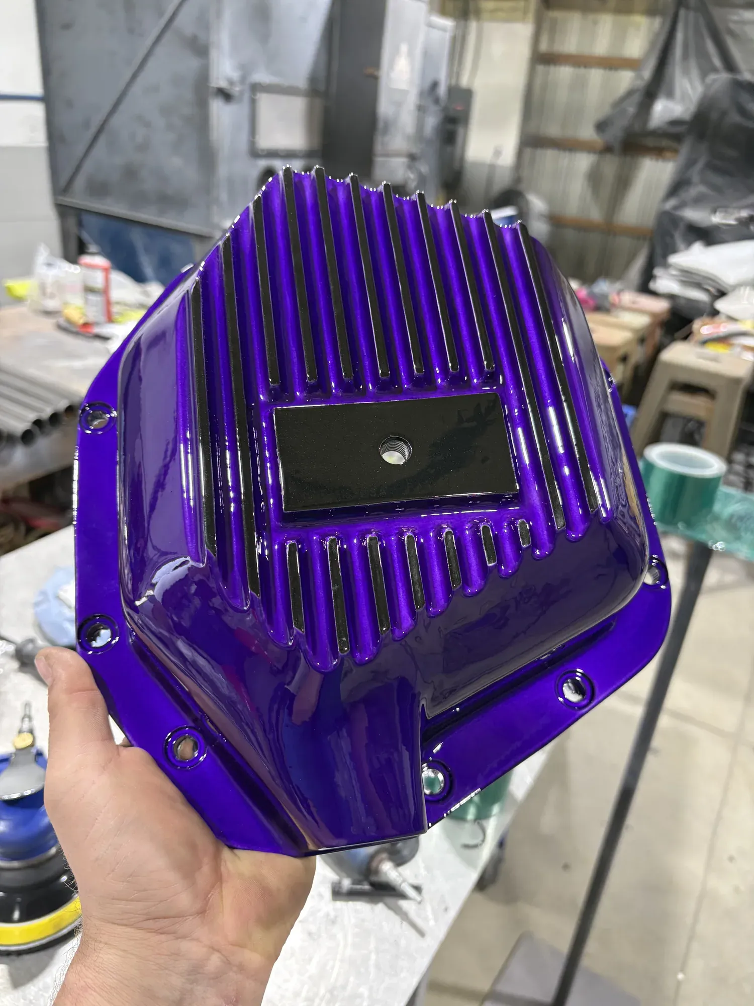 Differential cover powder coated in deep purple with a machined face