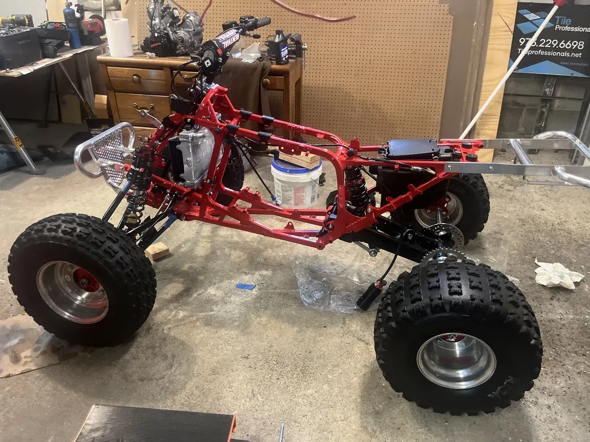 ATV frame powder coated bright red and rebuilt with suspension and wheels fitted
